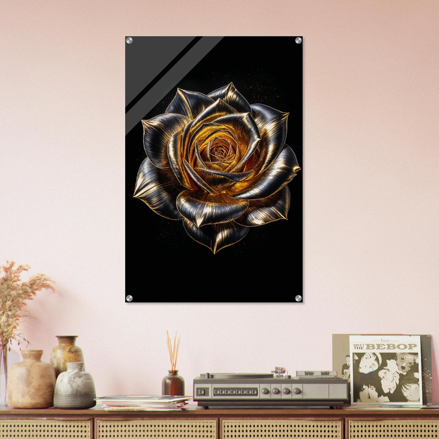 Decorative wall art of a gold rose on a black background, displayed on a shelf with decorative items.