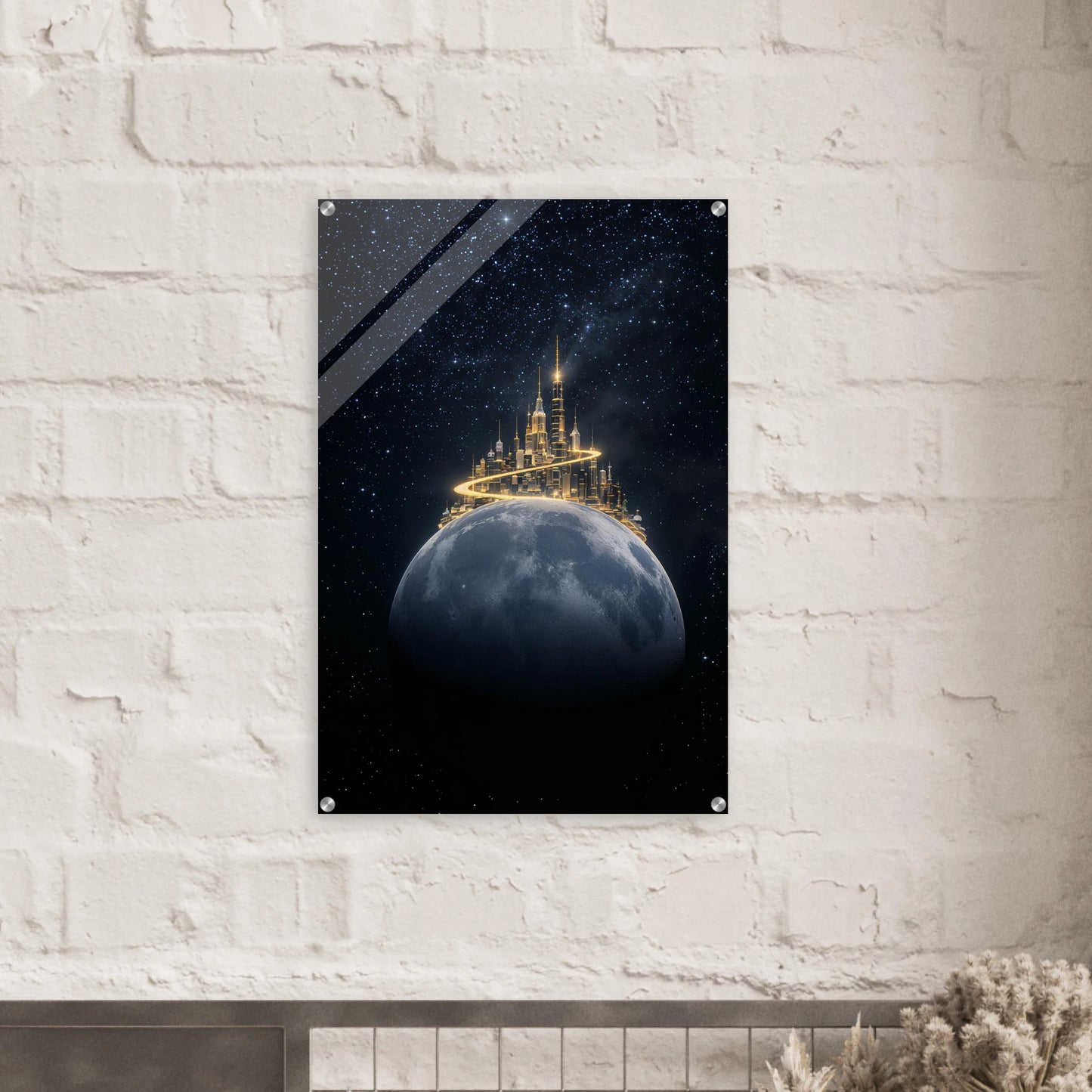 artwork of a castle on a moon with a starry night sky, mounted on a white brick wall.