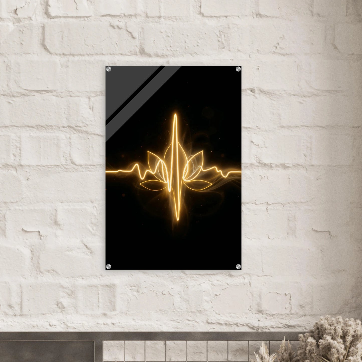 Decorative wall art with a gold leaf design on a black background, mounted on a white brick wall.
