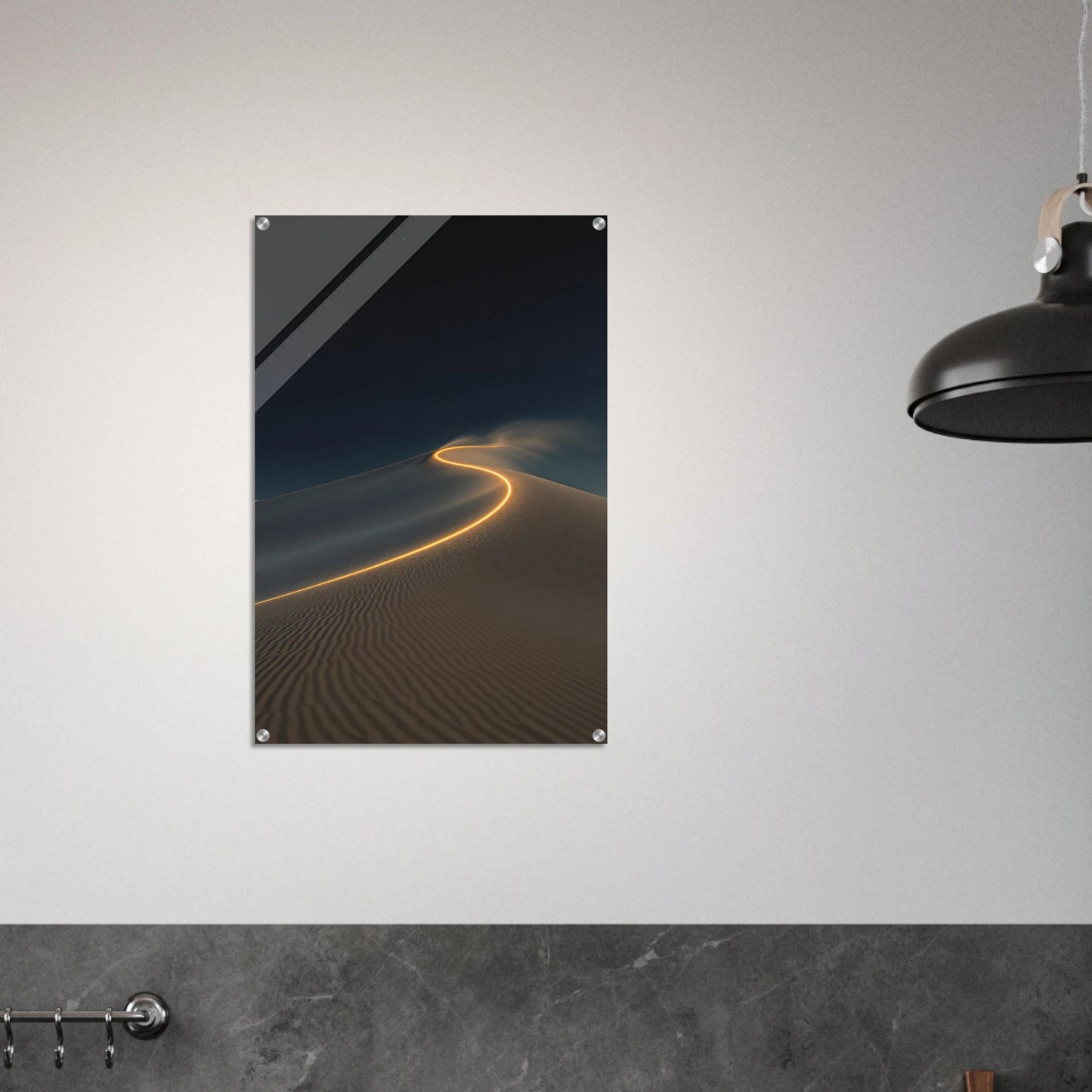 Poster of a desert landscape with a glowing line on a gray wall.