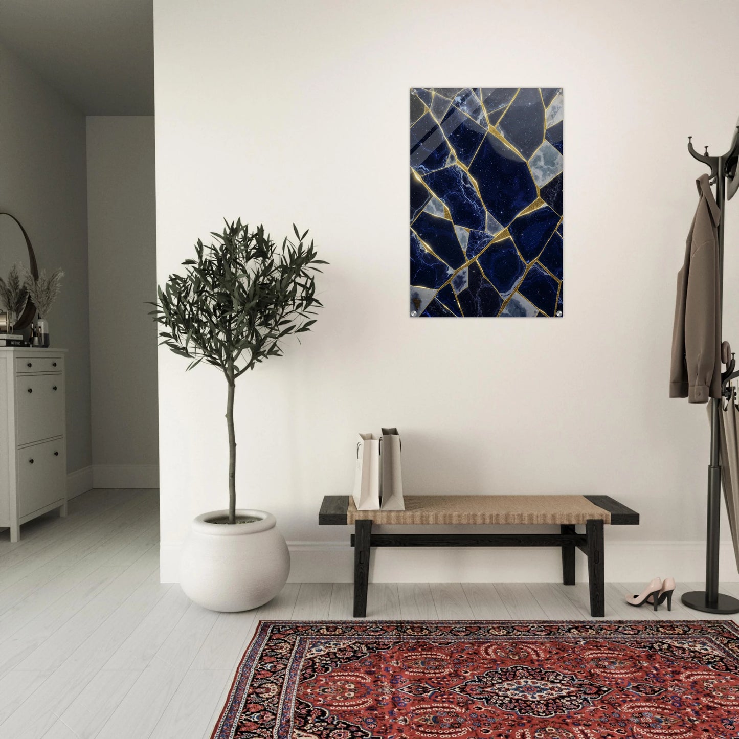 Modern interior with a bench, plant, and abstract art on the wall.