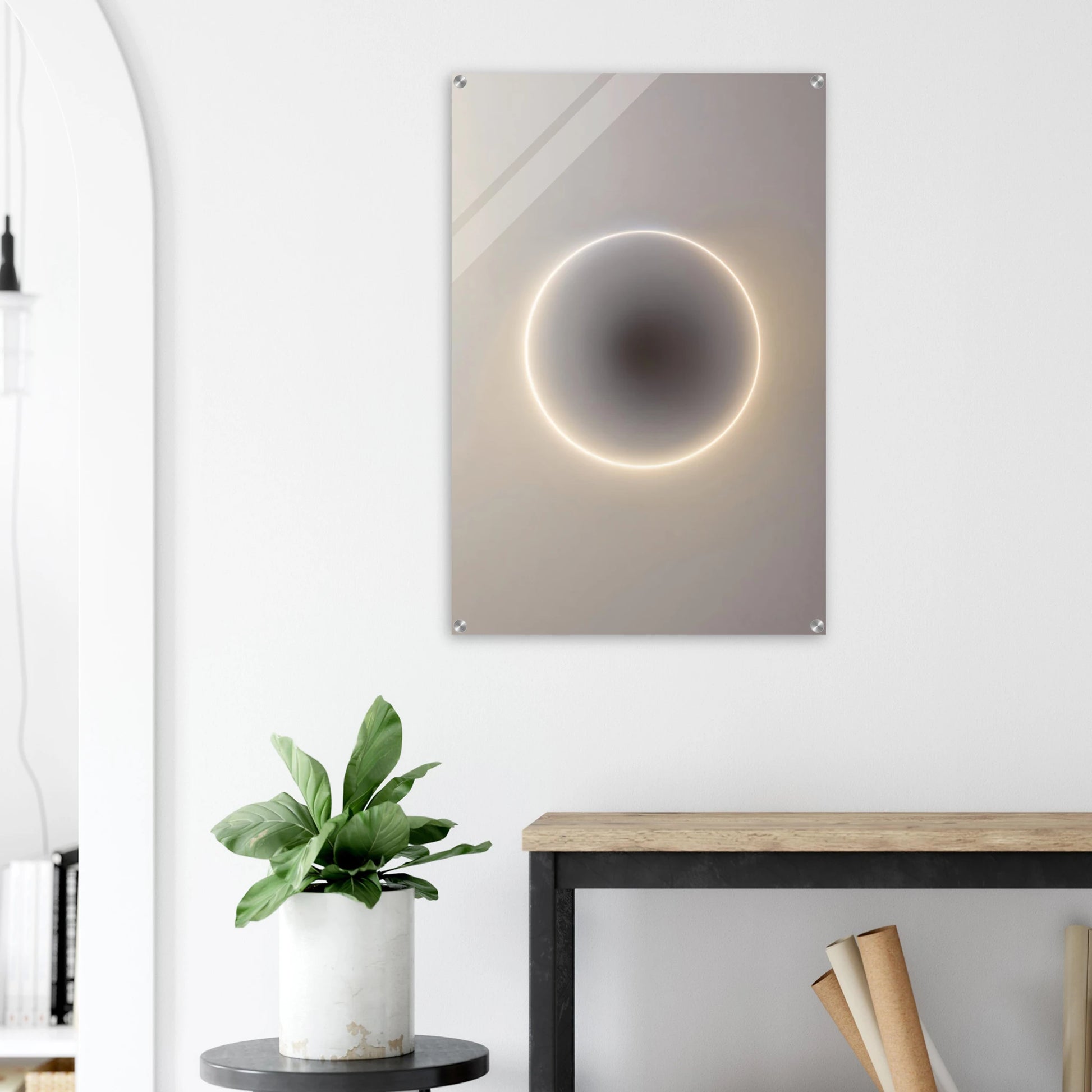 Modern wall art piece with circular design and glowing edge in a minimalistic room.