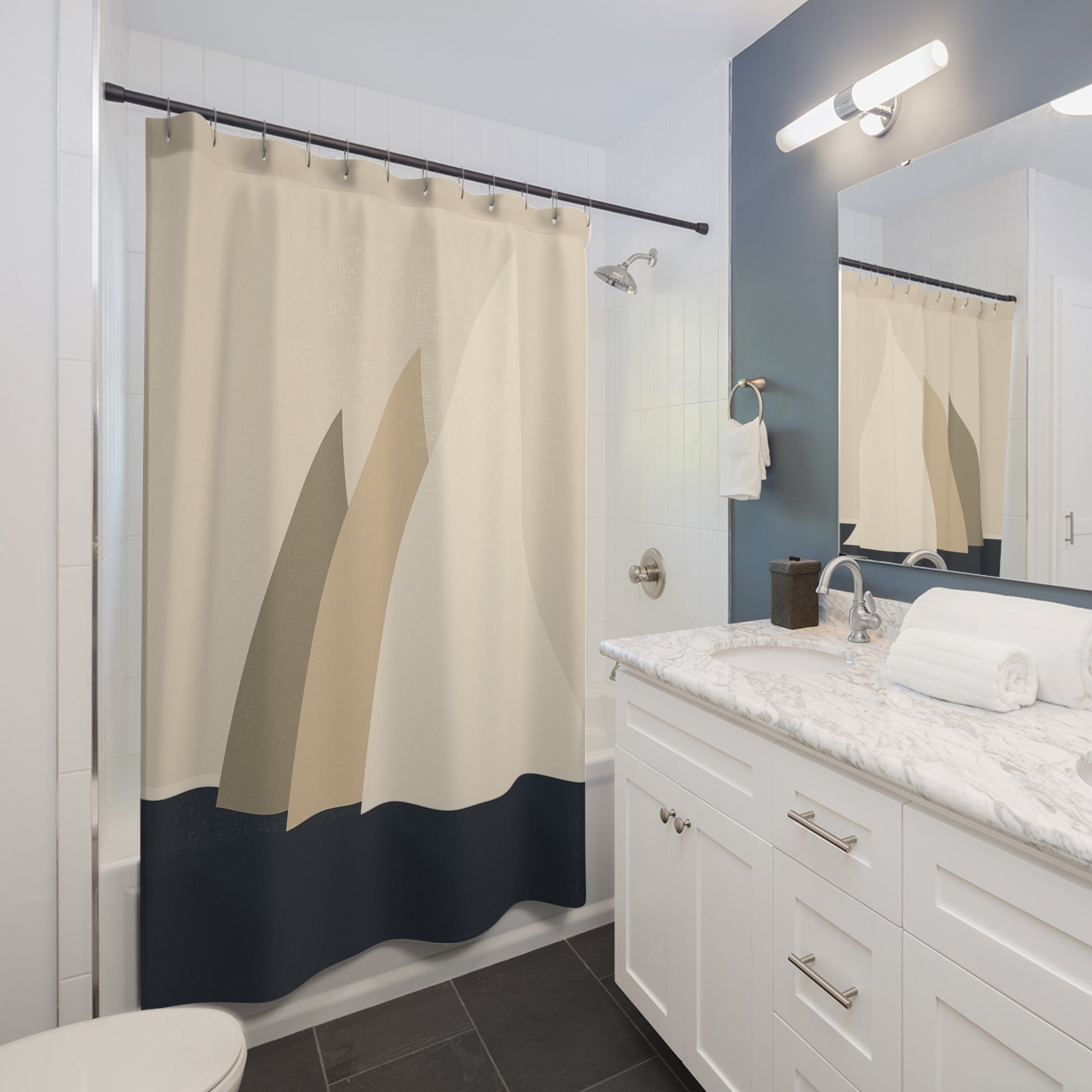 Bathroom with a beige and navy shower curtain, white vanity, and mirror.