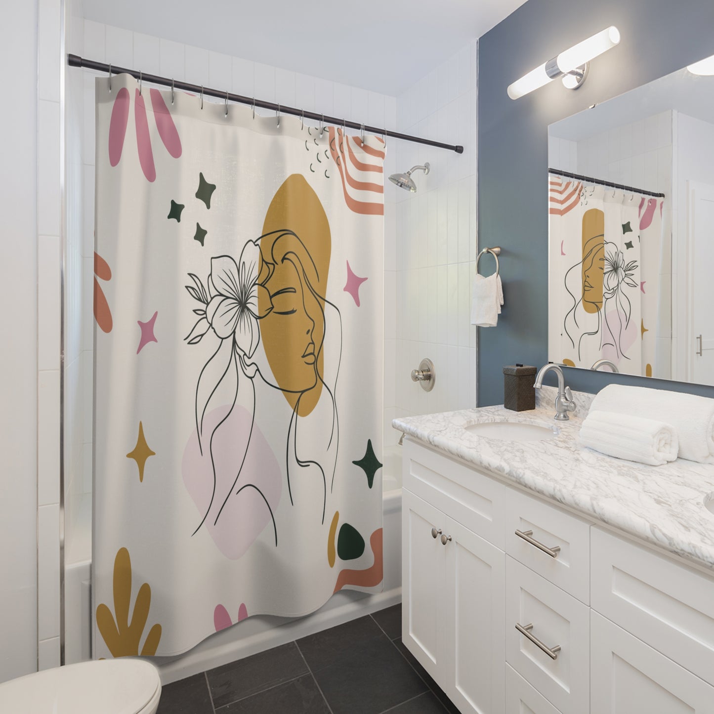 Bathroom with a shower curtain featuring a woman's face design, white vanity, and mirror.