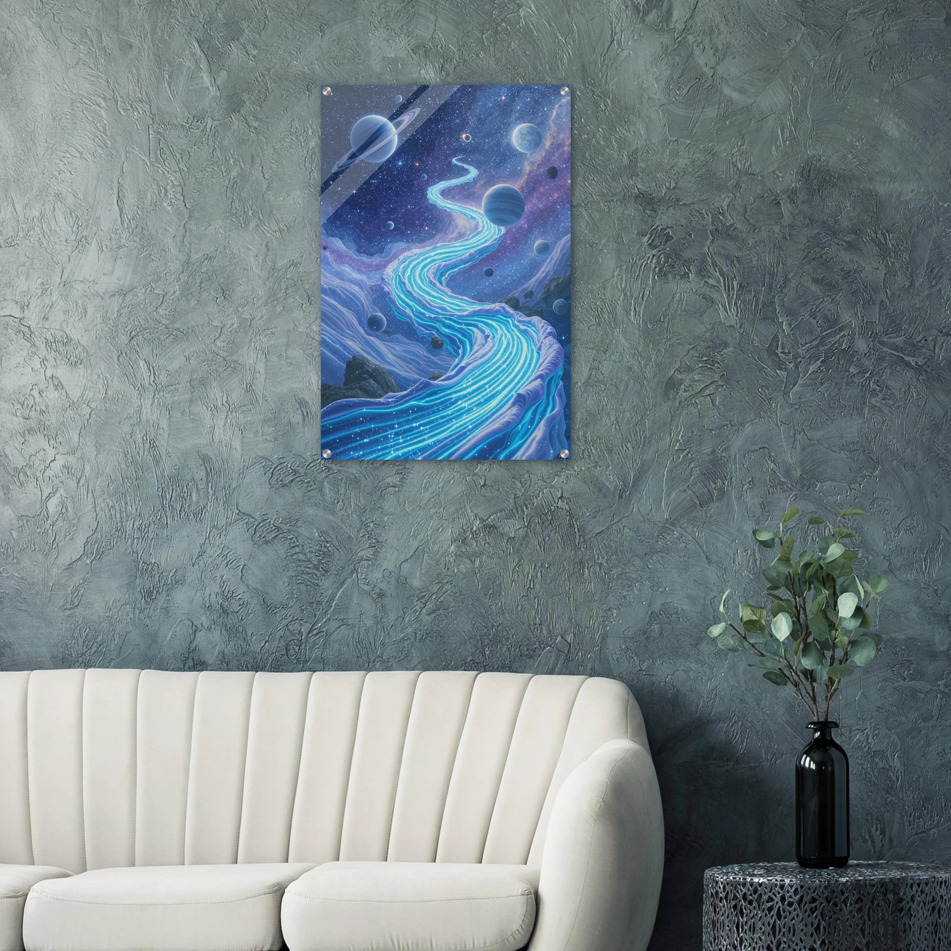 Abstract space-themed artwork on a gray wall above a beige sofa.