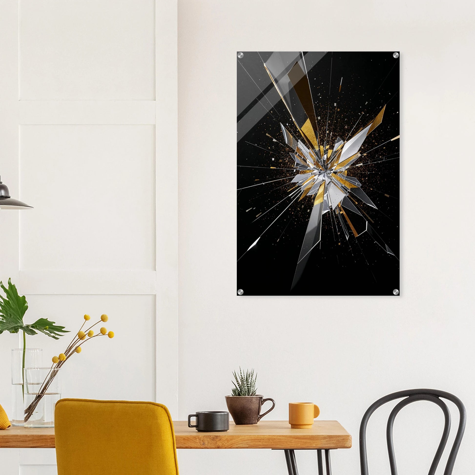 Abstract art piece with shattered glass design on a wall above a table with decor items.