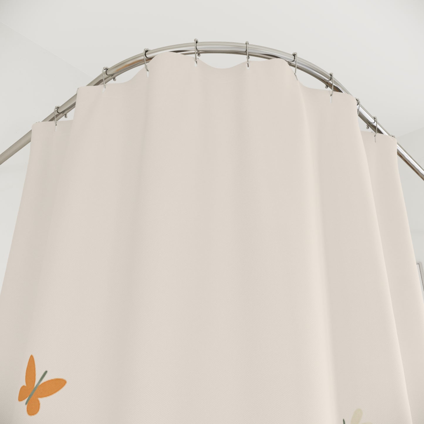 Beige curtain on a metal rod with a plain background