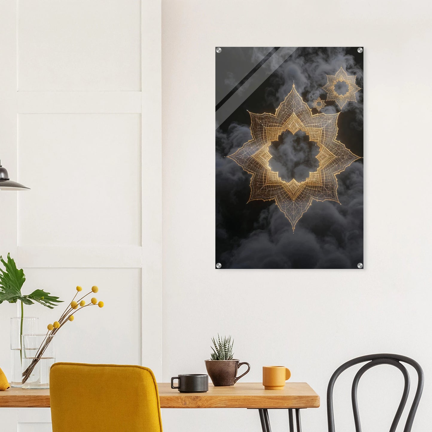 Decorative wall art with geometric design on a black background in a room with a table and chairs.