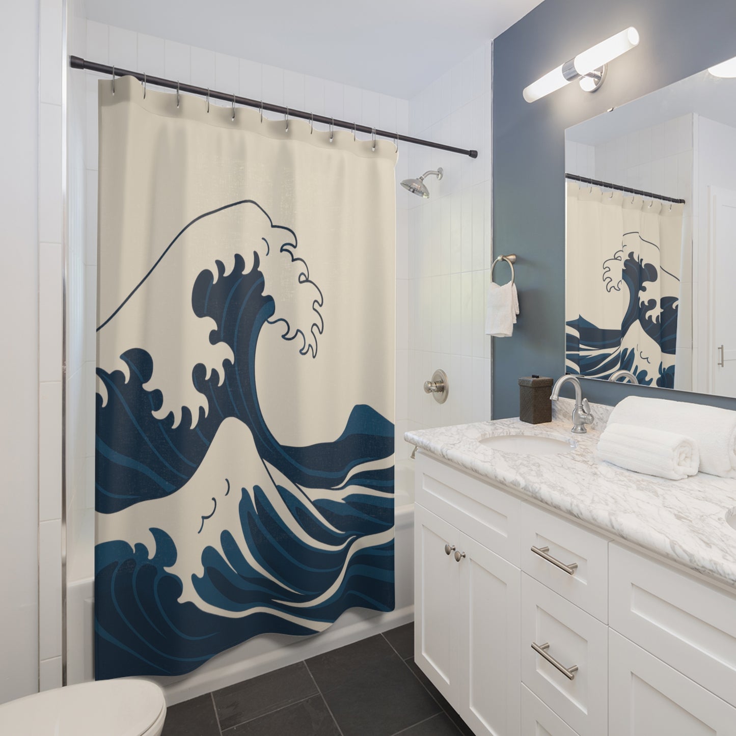 Bathroom with a wave-patterned shower curtain and white vanity.