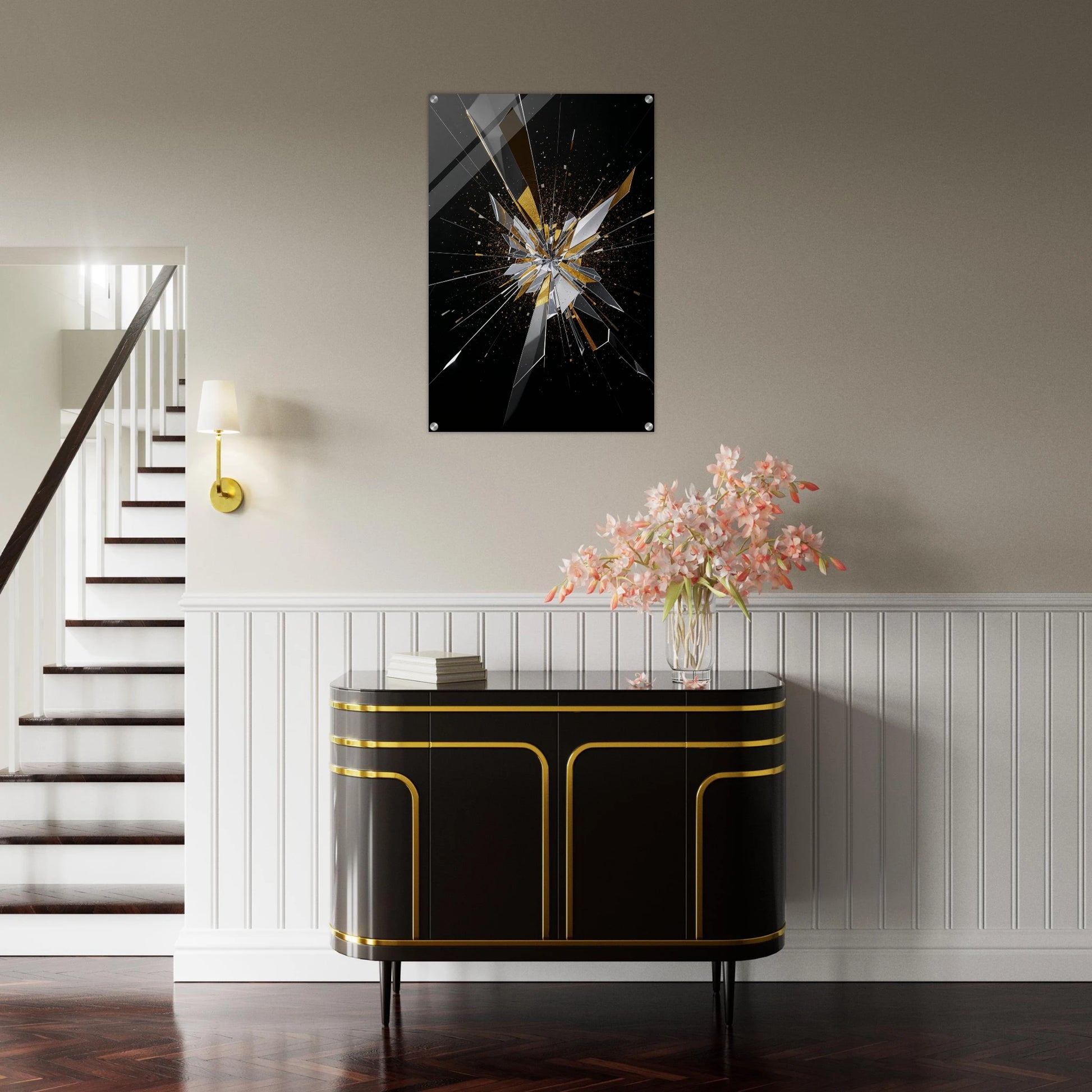 Modern interior with a black and gold cabinet, flowers, and a shattered glass artwork on the wall.