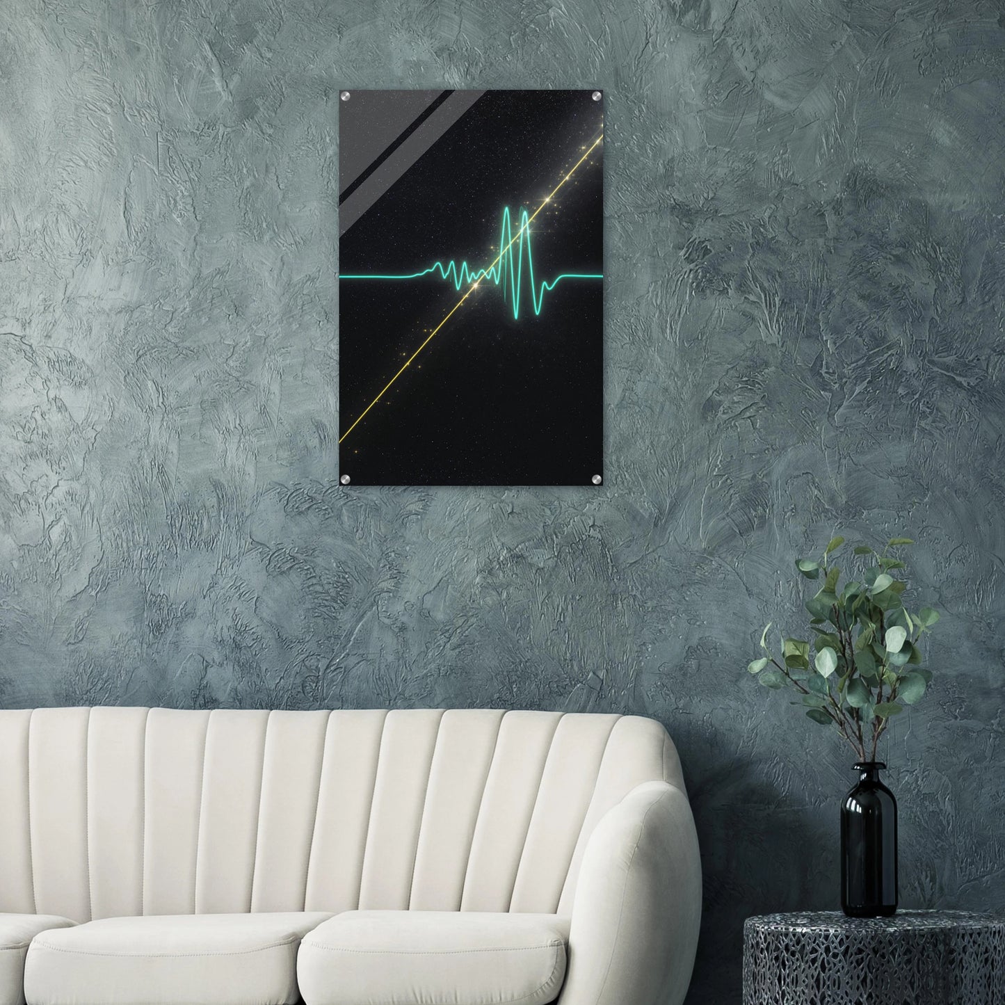 Modern interior with a wall art piece on a textured gray wall, a white sofa, and a plant.