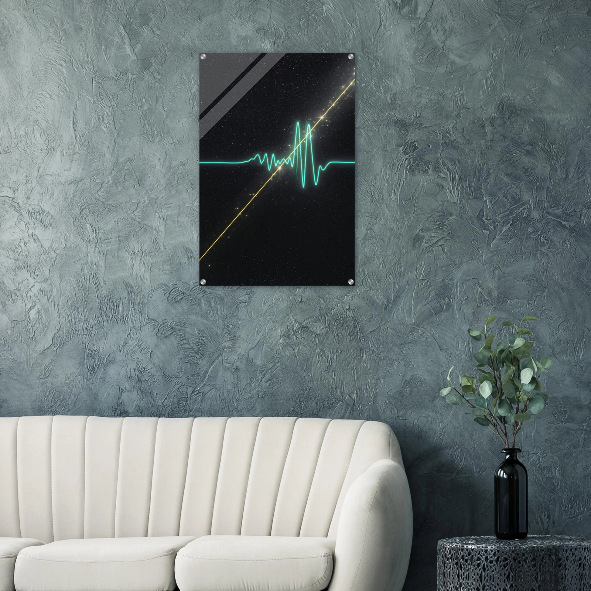 Modern interior with a wall art piece on a textured gray wall, a white sofa, and a plant.