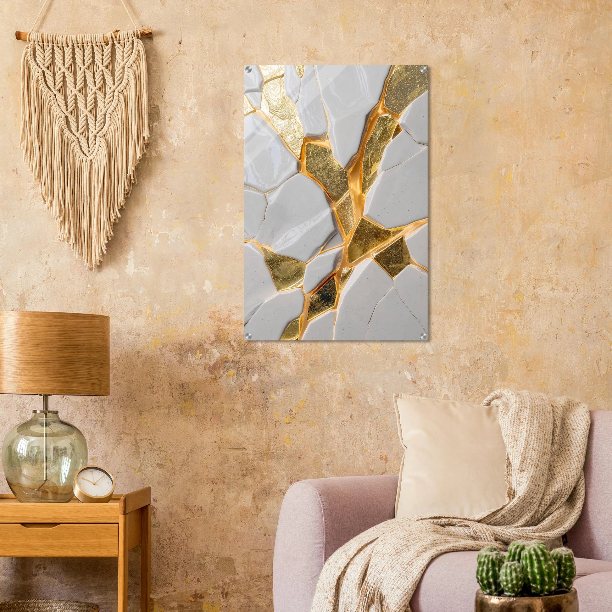Decorative abstract wall art piece on a beige wall with a lamp and plant in the foreground.