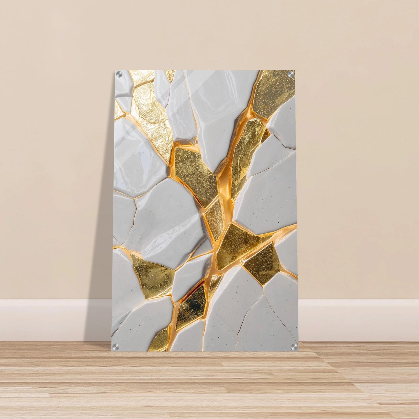 Abstract art piece with gold and gray geometric design on a beige wall.