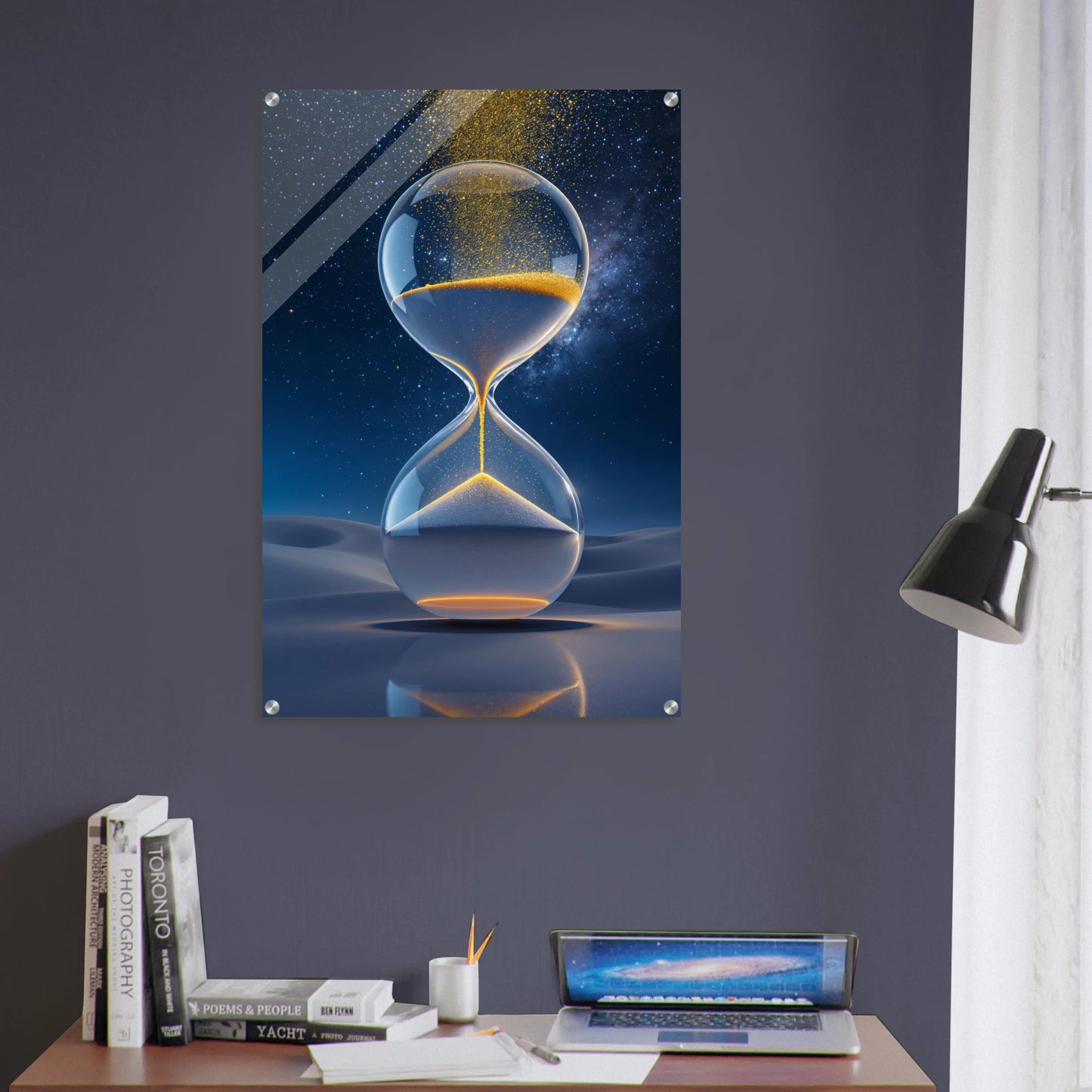 Futuristic hourglass design on a wall above a desk with books and a laptop.