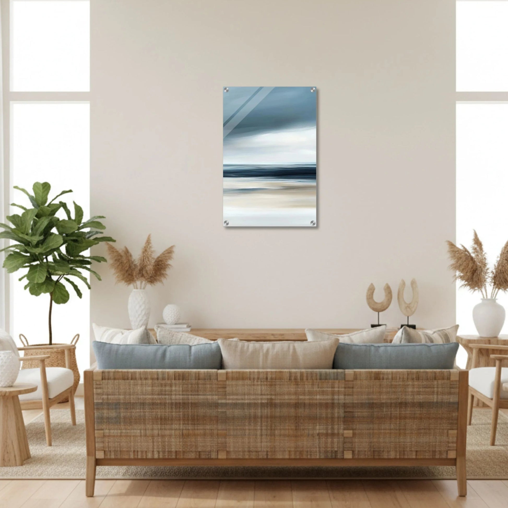 Modern living room with a wicker sofa, abstract painting, and decorative plants.