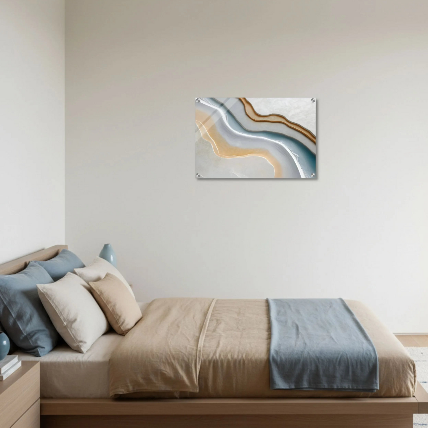 Bedroom with a bed and abstract wall art on a plain wall