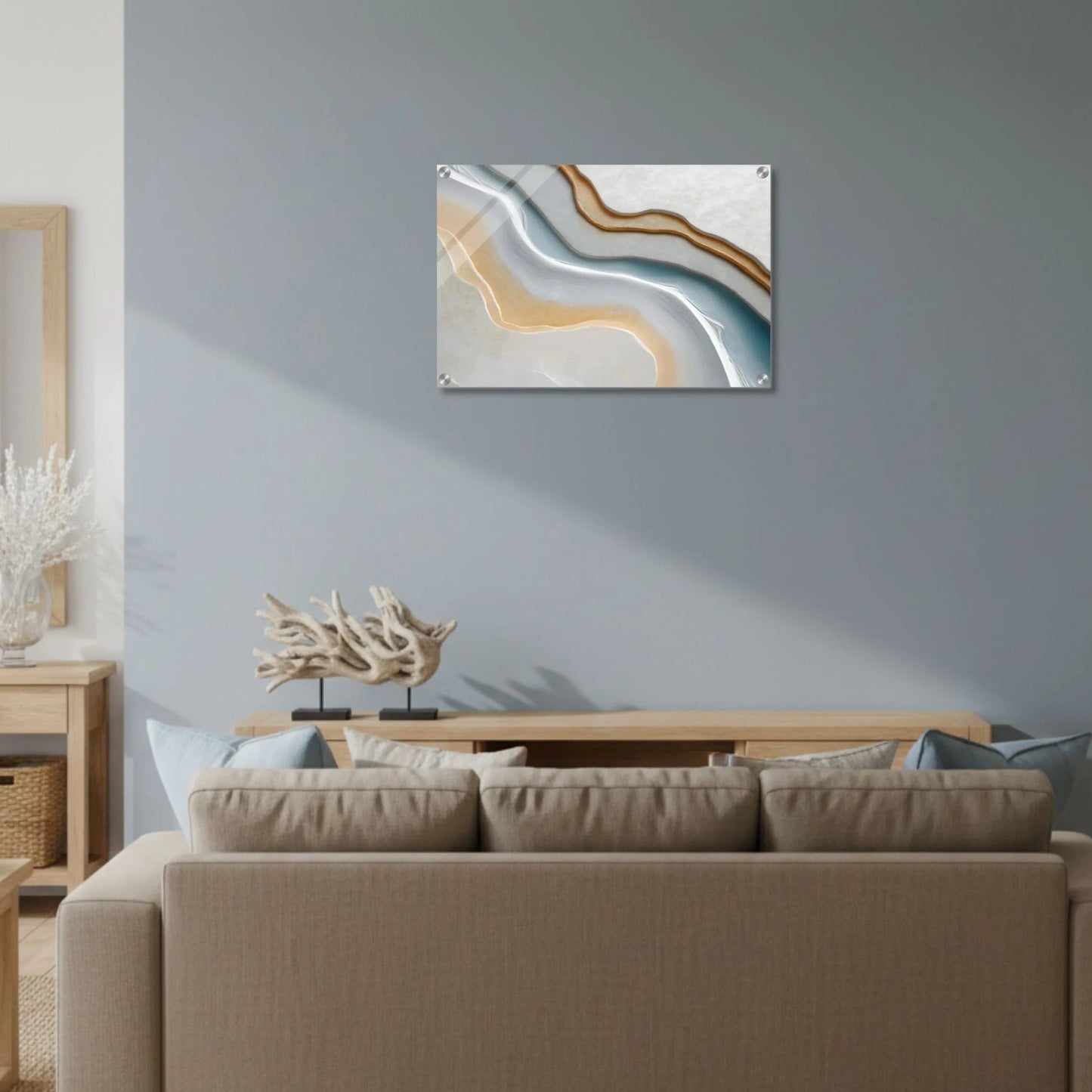 Living room with a beige sofa, coffee table, and abstract wall art on a light blue wall.