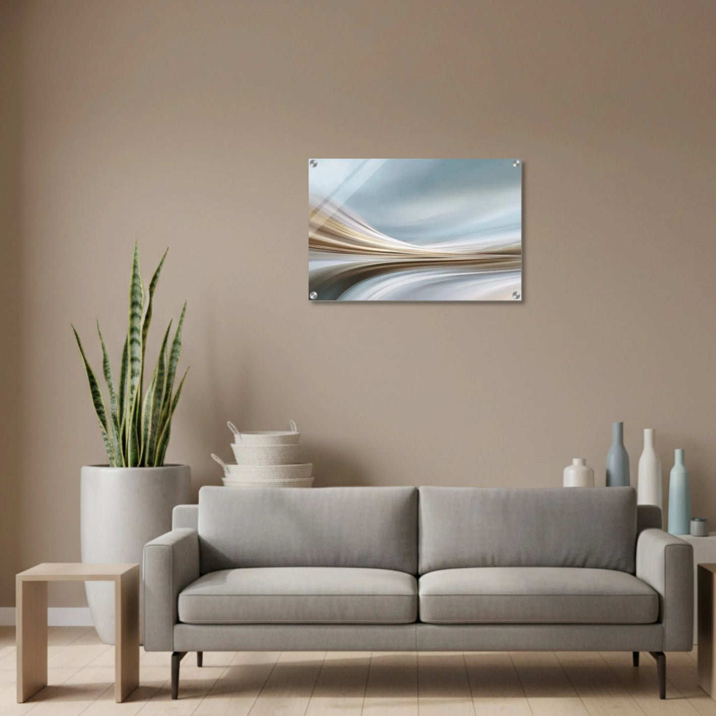 Modern living room with a gray sofa, decorative items, and a wall art piece.