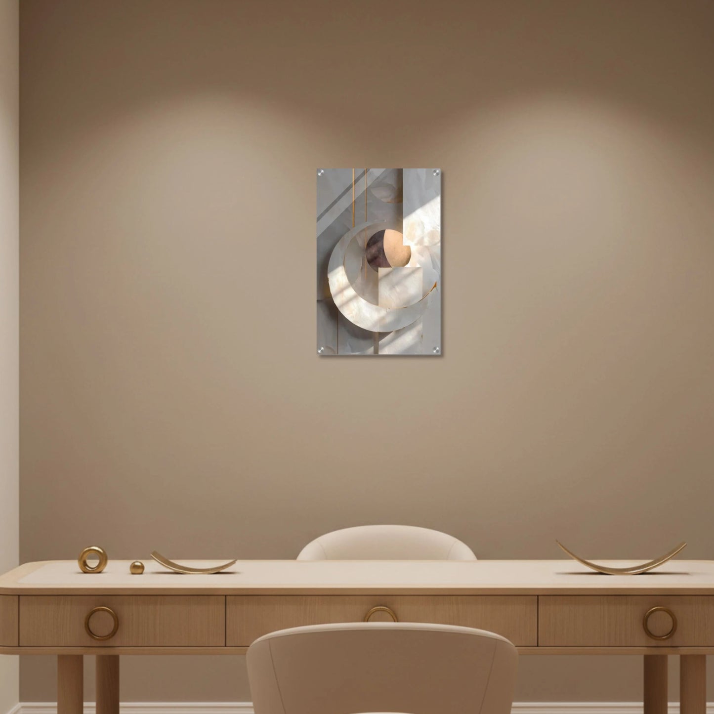 Decorative wall mirror on a beige wall above a wooden desk with chairs.