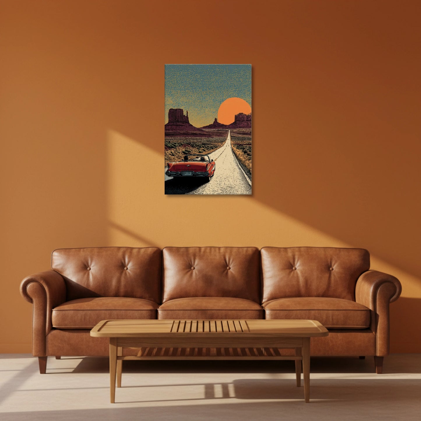 Brown leather sofa in a living room with a painting of a desert scene on the wall.