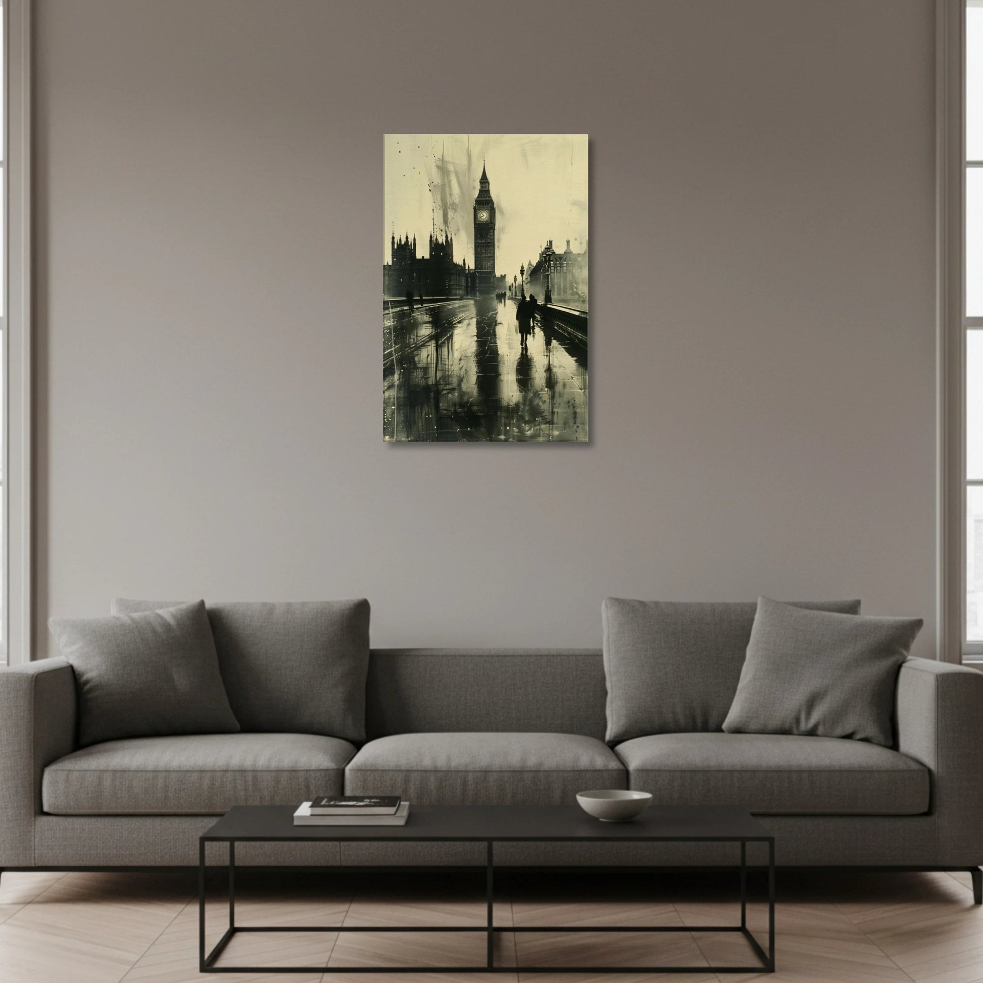 Gray sofa in a living room with a painting of Big Ben on the wall.
