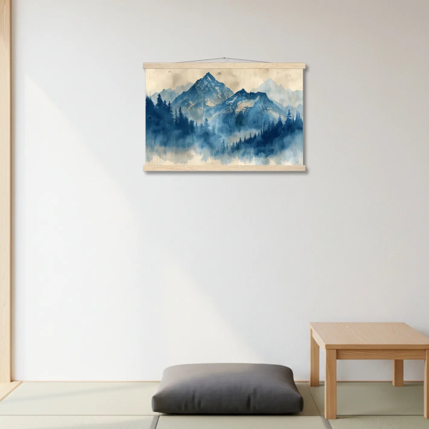 Framed mountain landscape painting on a wall with a wooden table and cushion below.