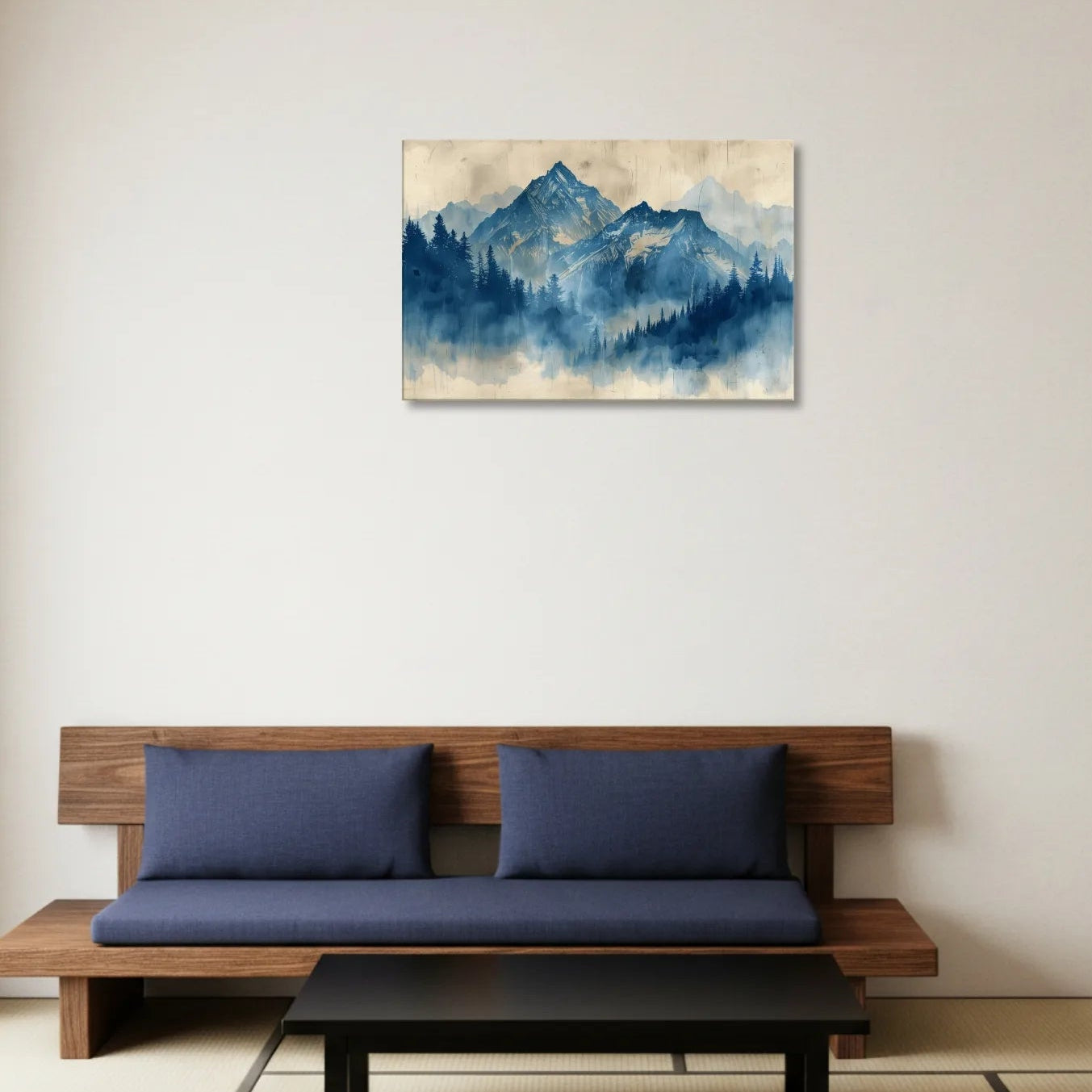 Wooden bench with blue cushions in a room with a mountain painting on the wall.