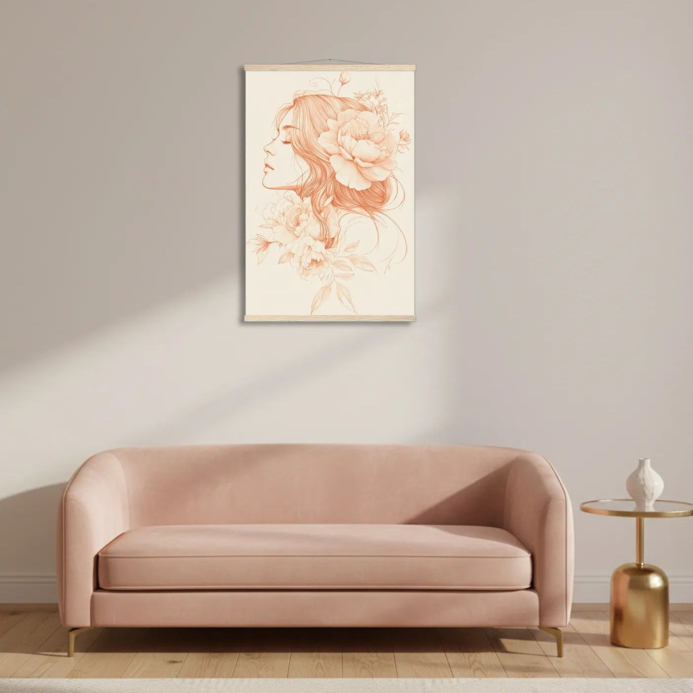 Pink sofa in a room with a framed artwork on the wall and a gold side table.