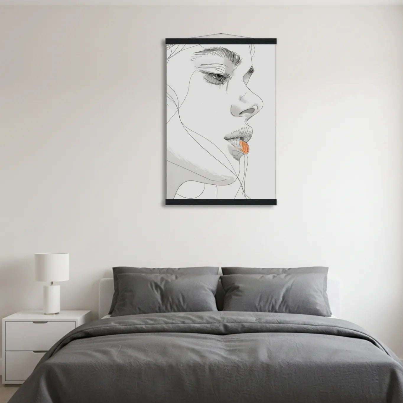Bedroom with gray bedding and a framed black and white art print on the wall.